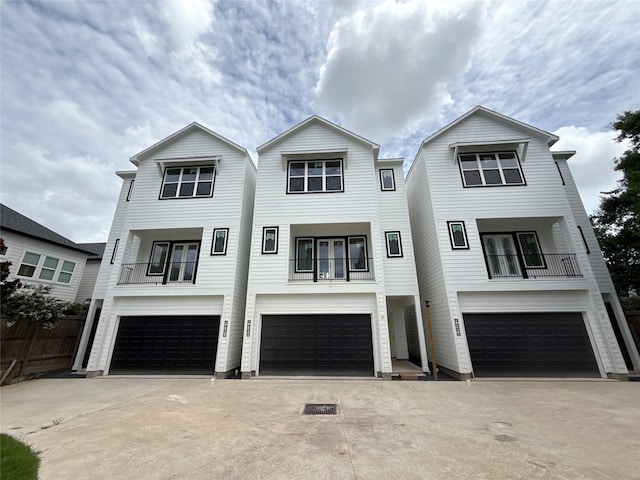 9426 Campbell Rd Unit B, Houston, TX 77080 - coastal home featuring a balcony, an attached garage, driveway, and french doors
