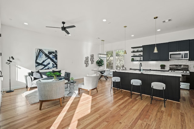 9426 Campbell Rd Unit B, Houston, TX 77080 - kitchen with light countertops, appliances with stainless steel finishes, light wood-type flooring, recessed lighting, and tasteful backsplash