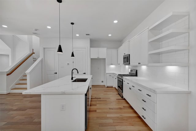 9426 Campbell Rd Unit B, Houston, TX 77080 - kitchen with stainless steel appliances, light wood finished floors, recessed lighting, open shelves, and white cabinets