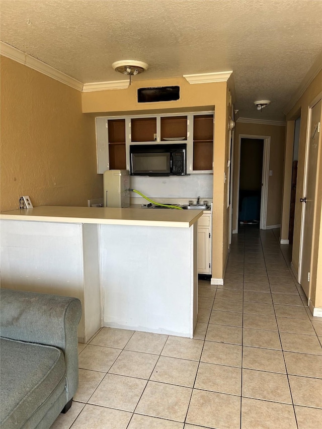 6300 Seawall Blvd Unit 3212, Galveston, TX 77551 - kitchen with a textured ceiling, open shelves, light tile patterned floors, crown molding, and black microwave