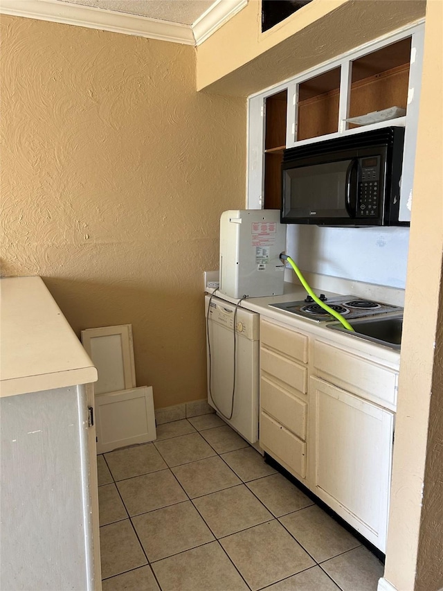 6300 Seawall Blvd Unit 3212, Galveston, TX 77551 - kitchen featuring a textured wall, light tile patterned flooring, black microwave, light countertops, and ornamental molding