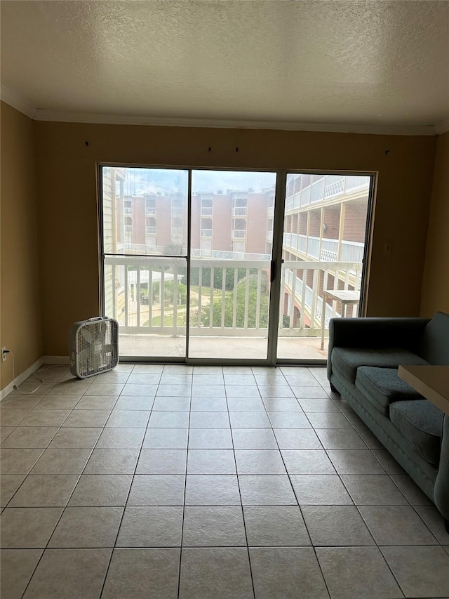 6300 Seawall Blvd Unit 3212, Galveston, TX 77551 - tiled living area featuring plenty of natural light, a textured ceiling, and crown molding
