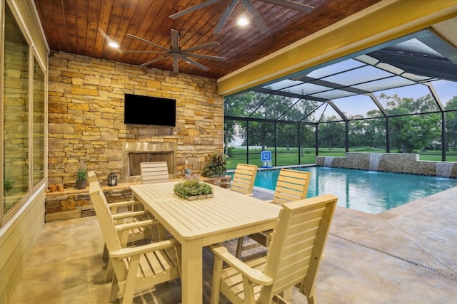 3848 S Main St, Anahuac, TX 77514 - view of patio with an outdoor stone fireplace, ceiling fan, an outdoor pool, outdoor dining area, and glass enclosure