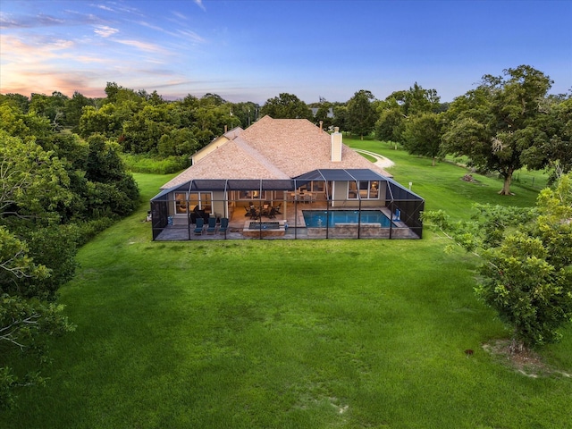 3848 S Main St, Anahuac, TX 77514 - rear view of property with an outdoor pool, a patio, a yard, a chimney, and glass enclosure