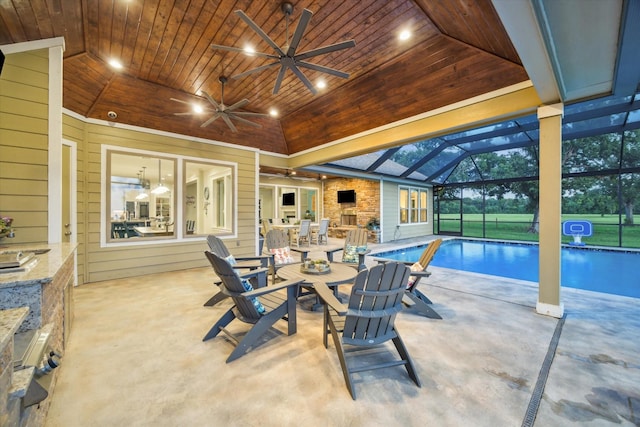 3848 S Main St, Anahuac, TX 77514 - view of patio with an outdoor pool, a ceiling fan, glass enclosure, and outdoor dining space