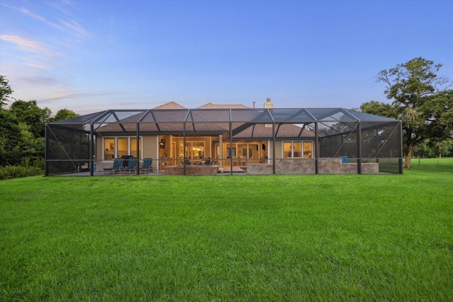 3848 S Main St, Anahuac, TX 77514 - rear view of house with a yard, a chimney, a lanai, and a patio