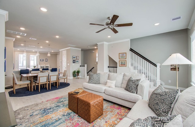 1912 Honey Mound Dr, Houston, TX 77080 - living room featuring a ceiling fan, light wood finished floors, recessed lighting, crown molding, and stairway