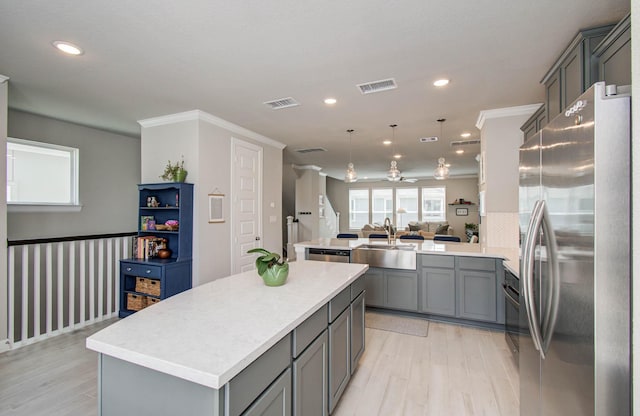 1912 Honey Mound Dr, Houston, TX 77080 - kitchen featuring gray cabinets, stainless steel appliances, a peninsula, open floor plan, and a center island