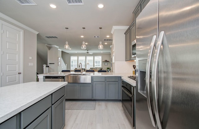 1912 Honey Mound Dr, Houston, TX 77080 - kitchen with gray cabinetry, appliances with stainless steel finishes, a peninsula, open floor plan, and recessed lighting