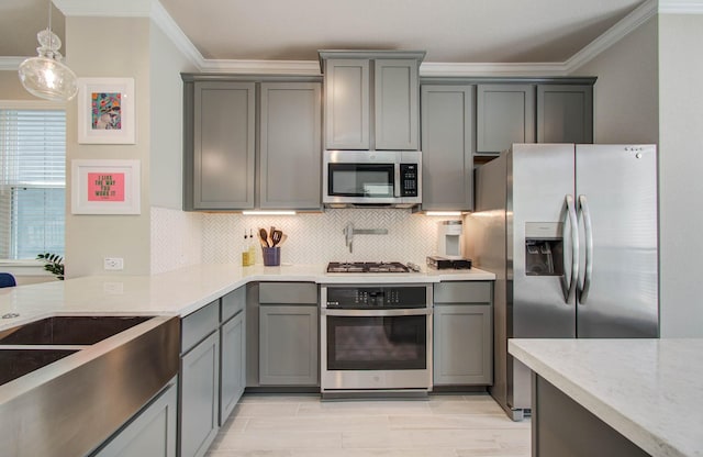 1912 Honey Mound Dr, Houston, TX 77080 - kitchen with ornamental molding, appliances with stainless steel finishes, gray cabinetry, decorative backsplash, and light stone counters