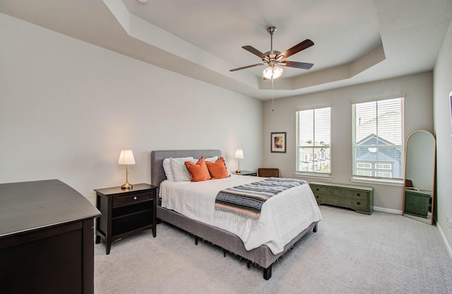 1912 Honey Mound Dr, Houston, TX 77080 - bedroom featuring a tray ceiling, light carpet, and a ceiling fan
