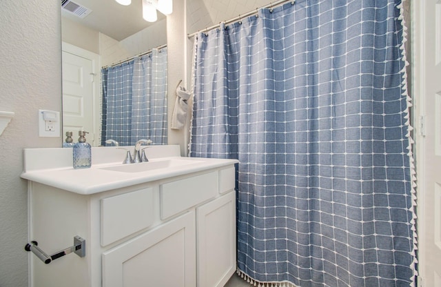 1912 Honey Mound Dr, Houston, TX 77080 - bathroom featuring vanity, a textured wall, and a shower with curtain
