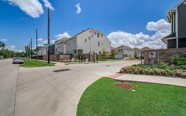 1912 Honey Mound Dr, Houston, TX 77080 - view of concrete road with a residential view, street lights, sidewalks, and curbs