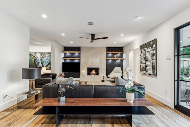 5623 Oak Trail Ln, Houston, TX 77091 - living area featuring a premium fireplace, wood finished floors, ceiling fan, and recessed lighting