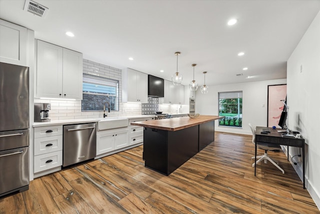 5623 Oak Trail Ln, Houston, TX 77091 - kitchen with wooden counters, appliances with stainless steel finishes, decorative backsplash, dark wood-style flooring, and recessed lighting