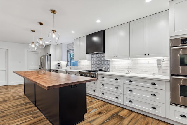 5623 Oak Trail Ln, Houston, TX 77091 - kitchen with wooden counters, extractor fan, tasteful backsplash, stainless steel appliances, and a center island