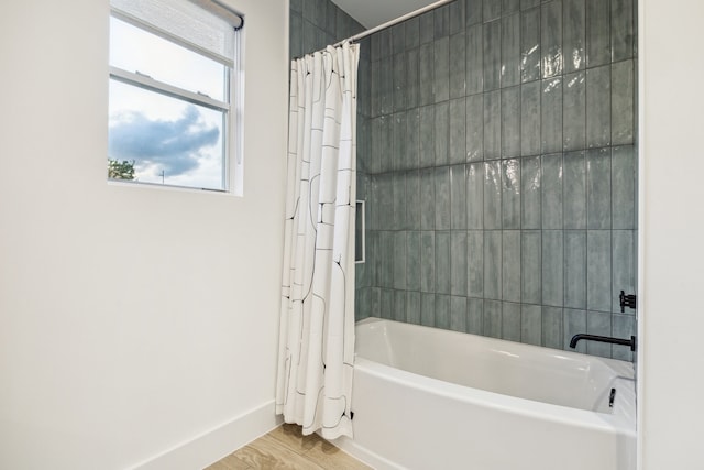 5623 Oak Trail Ln, Houston, TX 77091 - bathroom featuring shower / bathtub combination with curtain and wood finished floors