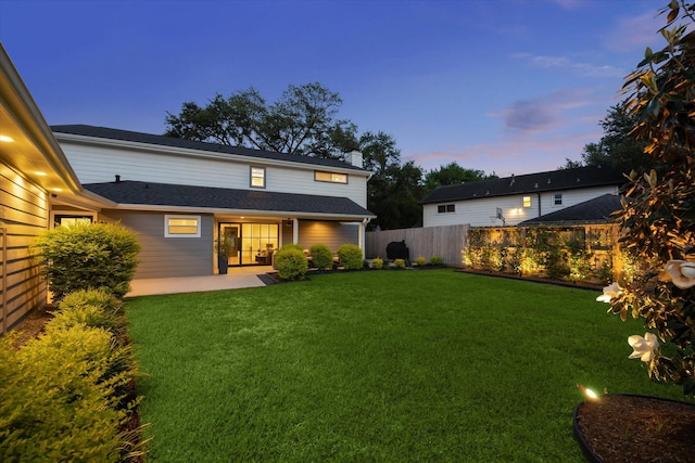 5623 Oak Trail Ln, Houston, TX 77091 - back of house at dusk with a fenced backyard and a patio area