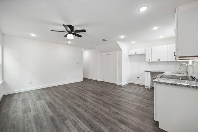 2310 Wavell St, Houston, TX 77088 - kitchen featuring a ceiling fan, white cabinetry, dark wood-type flooring, recessed lighting, and light stone countertops