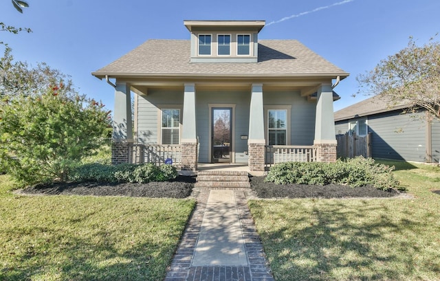 16803 Amelia Island Dr, Cypress, TX 77433 - craftsman-style home with covered porch, a front lawn, and roof with shingles