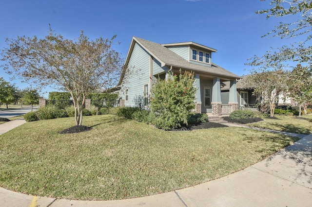 16803 Amelia Island Dr, Cypress, TX 77433 - view of front facade with brick siding, a front lawn, roof with shingles, and covered porch