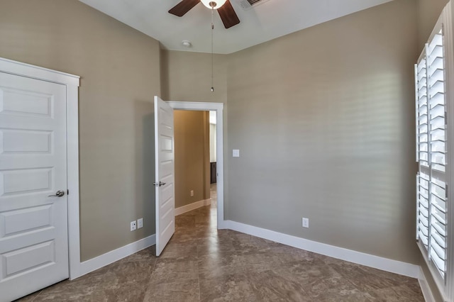 16803 Amelia Island Dr, Cypress, TX 77433 - unfurnished bedroom with baseboards and a ceiling fan