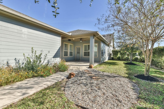 16803 Amelia Island Dr, Cypress, TX 77433 - back of house featuring a ceiling fan, a lawn, a patio, and roof with shingles