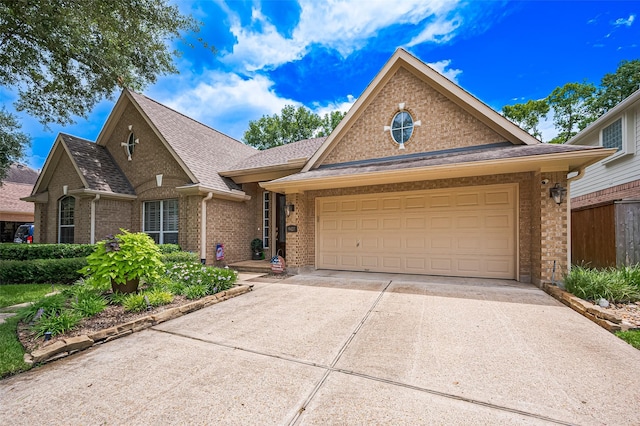 9427 Fern Wood Frst, Houston, TX 77040 - view of front of property featuring concrete driveway, brick siding, roof with shingles, and a garage