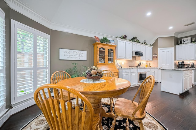 9427 Fern Wood Frst, Houston, TX 77040 - dining area featuring crown molding, dark wood-style flooring, recessed lighting, and vaulted ceiling