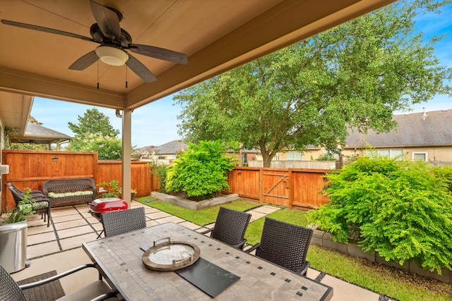 9707 Old Timber Ln, Spring, TX 77379 - fenced backyard with outdoor dining area, a patio area, ceiling fan, and an outdoor hangout area