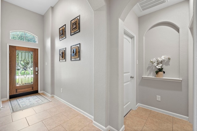 9707 Old Timber Ln, Spring, TX 77379 - foyer entrance featuring arched walkways and light tile patterned floors