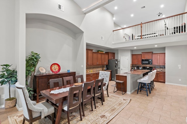 9707 Old Timber Ln, Spring, TX 77379 - dining space with high vaulted ceiling and recessed lighting