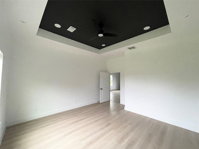 11735 Fleming Dr, Houston, TX 77013 - unfurnished room with a raised ceiling, ceiling fan, and light wood-type flooring