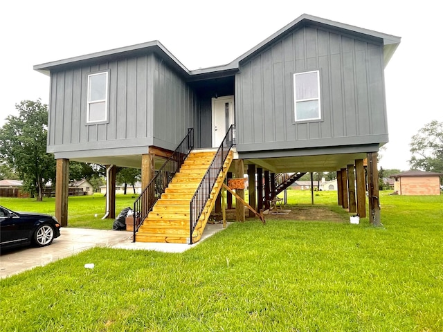 11735 Fleming Dr, Houston, TX 77013 - beach home with a carport, board and batten siding, a front yard, driveway, and stairway