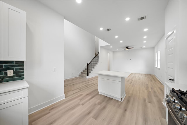 2012 Chew St, Houston, TX 77020 - kitchen with a ceiling fan, white cabinetry, light wood-type flooring, and recessed lighting