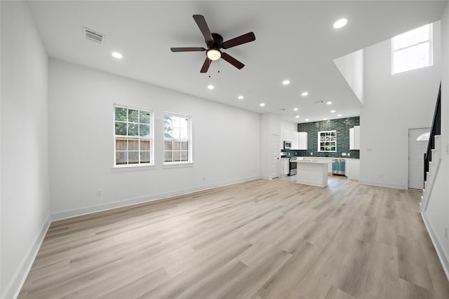 2012 Chew St, Houston, TX 77020 - unfurnished living room featuring a ceiling fan, recessed lighting, stairway, and light wood-style flooring