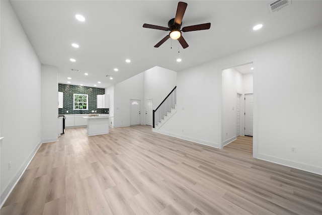 2012 Chew St, Houston, TX 77020 - unfurnished living room with recessed lighting, stairway, ceiling fan, and light wood-style flooring