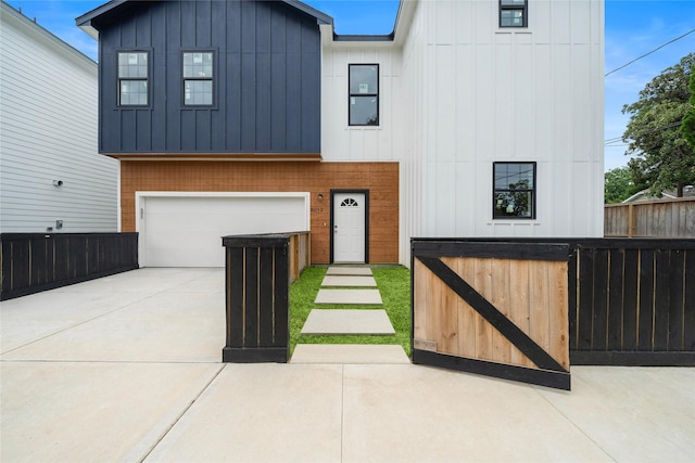 2012 Chew St, Houston, TX 77020 - view of front of property featuring driveway, an attached garage, and board and batten siding