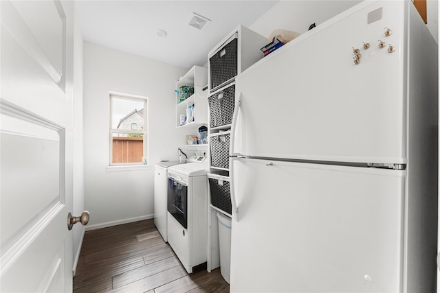 7202 Cordgrass Prairie Ln, Katy, TX 77493 - washroom featuring washing machine and dryer and wood finished floors