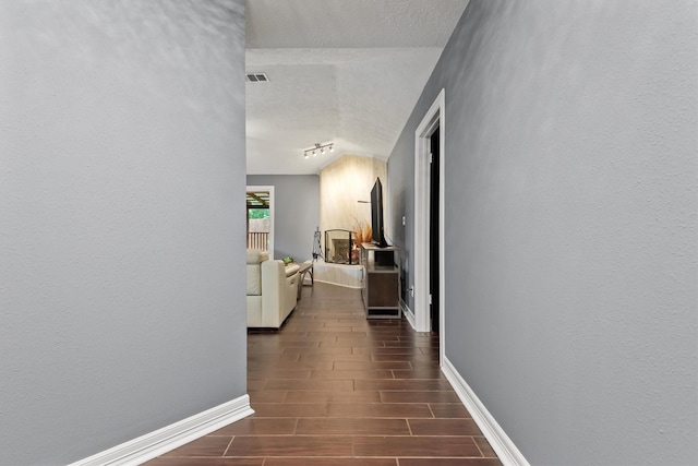 6510 Barrygate Dr, Spring, TX 77373 - corridor with wood finished floors, lofted ceiling, a textured ceiling, and a textured wall
