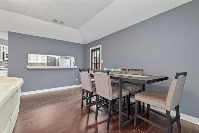 6510 Barrygate Dr, Spring, TX 77373 - dining area featuring wood finished floors, lofted ceiling, and a textured ceiling
