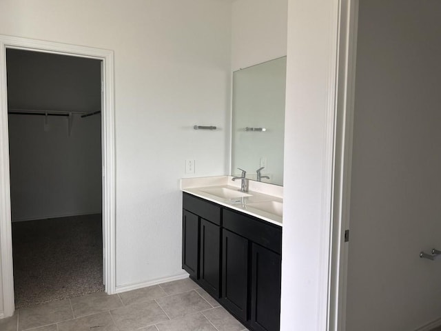14217 Dream Rd, New Caney, TX 77357 - bathroom with vanity, a walk in closet, and tile patterned floors