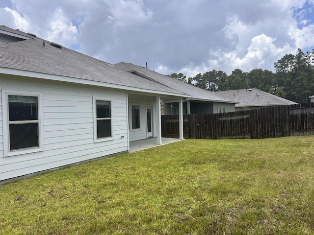 14217 Dream Rd, New Caney, TX 77357 - rear view of house featuring roof with shingles and a patio