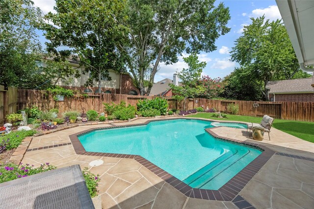2218 Lashley Ct, Katy, TX 77450 - view of swimming pool with a patio area, a fenced backyard, and a pool with connected hot tub