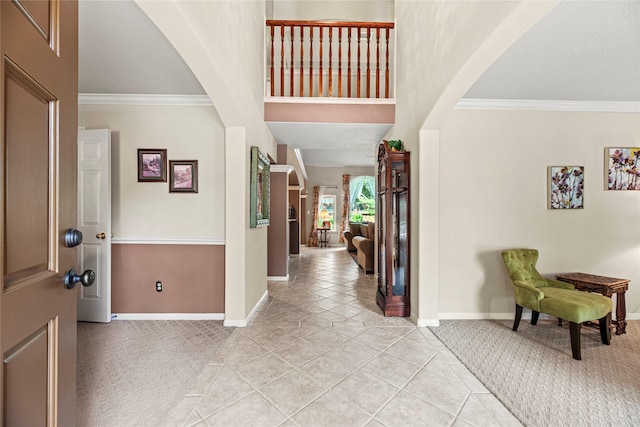 2218 Lashley Ct, Katy, TX 77450 - foyer with light colored carpet, ornamental molding, arched walkways, and light tile patterned floors