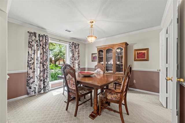 2218 Lashley Ct, Katy, TX 77450 - dining space with light carpet, crown molding, and a textured ceiling