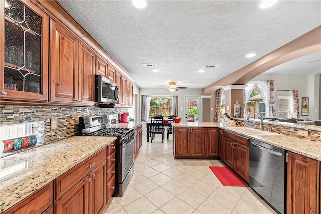 2218 Lashley Ct, Katy, TX 77450 - kitchen with stainless steel appliances, ceiling fan, light tile patterned floors, glass insert cabinets, and backsplash