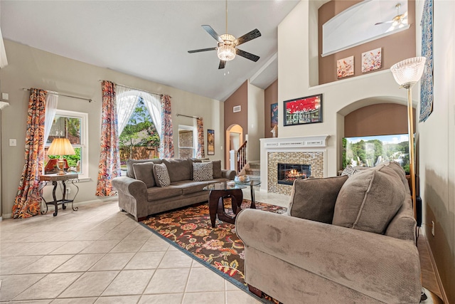 2218 Lashley Ct, Katy, TX 77450 - living room featuring ceiling fan, light tile patterned flooring, a fireplace, and high vaulted ceiling