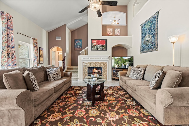 2218 Lashley Ct, Katy, TX 77450 - living area featuring high vaulted ceiling, ceiling fan, arched walkways, and a fireplace