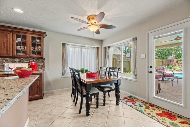 2218 Lashley Ct, Katy, TX 77450 - dining room featuring ceiling fan, light tile patterned flooring, a textured ceiling, and recessed lighting